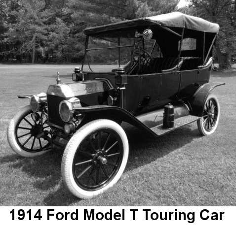 Black and white photo of a black 5-passenger convertible automobile, top up, with four doors, horizontally-divided windshield, running boards, and white tires on black wide-spoked wheels